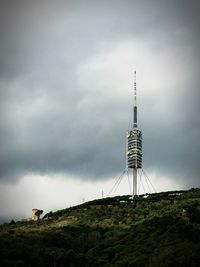 Low angle view of communications tower against sky