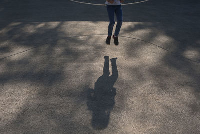 Low section of person walking on street