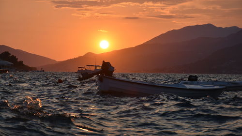 Boat in sea at sunset