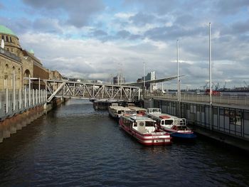 Boats in river with buildings in background