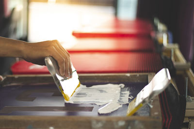 Cropped hand of person working in workshop