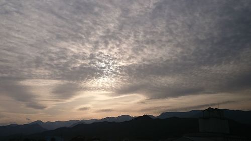 Scenic view of mountains against sky at sunset