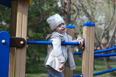 Girl standing on outdoor play equipment at playground