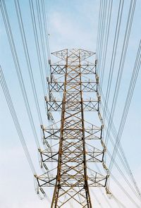 Low angle view of electricity pylon against sky