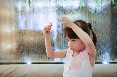 Close-up of girl holding hair clip