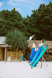 Surfboards at beach against sky