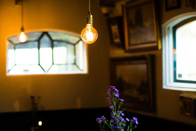 Close-up of illuminated electric lamp at home