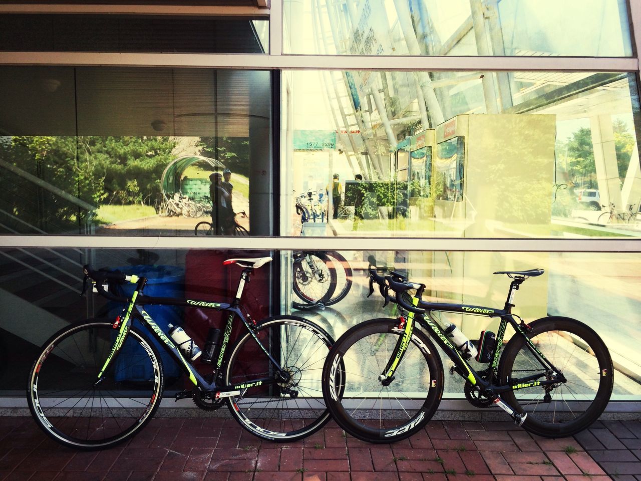 bicycle, built structure, architecture, building exterior, land vehicle, transportation, mode of transport, stationary, parking, parked, city, building, low angle view, day, street, wall - building feature, outdoors, no people, lighting equipment, window