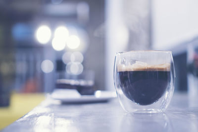 Close-up of coffee in glass on table