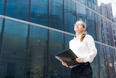Business woman successful woman walking outdoors, corporate building, outdoor
