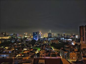 High angle view of illuminated buildings in city at night