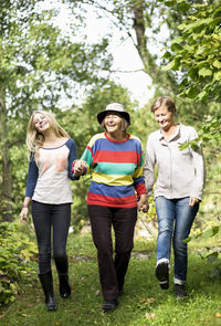 Happy three generation females walking in park
