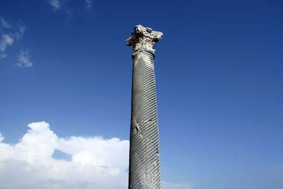 Low angle view of sculpture against blue sky