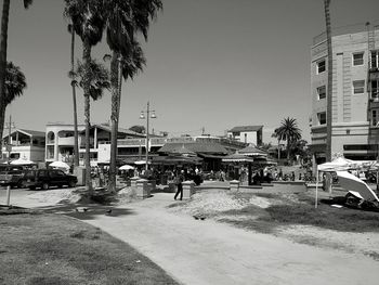 Cars on road with buildings in background