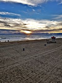 Scenic view of beach against sky during sunset