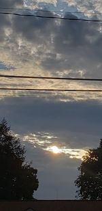 Low angle view of silhouette trees against sky at sunset