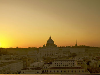 Buildings against sky during sunset in city