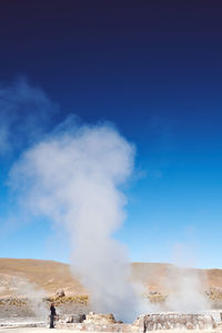 Panoramic view geyser releasing steam on a volcano