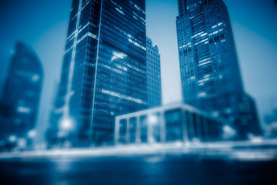 Reflection of illuminated buildings in city at night