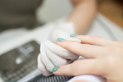 Cropped hands of woman using mobile phone