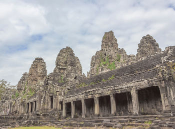 Low angle view of temple against cloudy sky