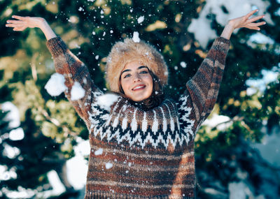 Portrait of smiling woman in snow