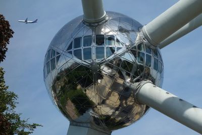 Low angle view of communications tower against sky