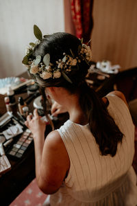 Young woman applying makeup.