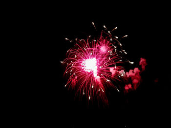 Low angle view of firework display at night