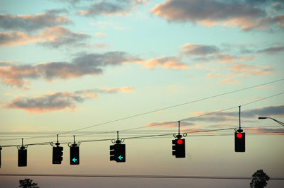 Low angle view of traffic lights against sky