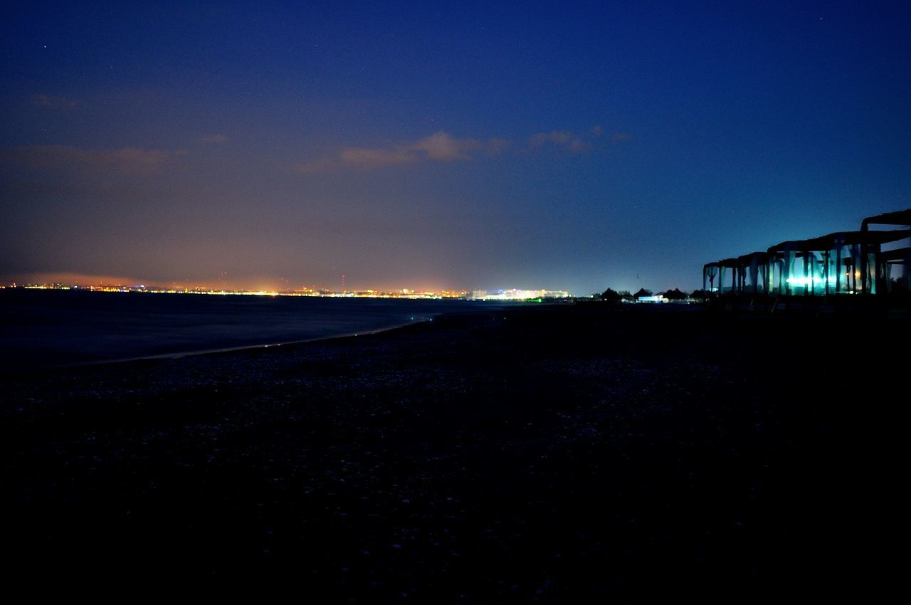 illuminated, copy space, night, clear sky, blue, building exterior, built structure, architecture, dusk, sky, sunset, tranquil scene, landscape, scenics, tranquility, nature, house, beauty in nature, outdoors, silhouette