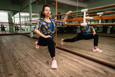 Full length of young woman dancing