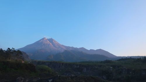 Scenic view of mountains against blue sky