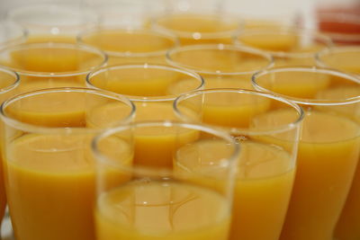 Close-up of orange juices served on table
