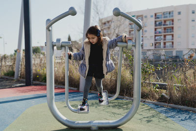 Portrait of a four-year-old girl in a daytime park with a jacket