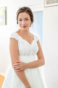 Portrait of bride standing at home