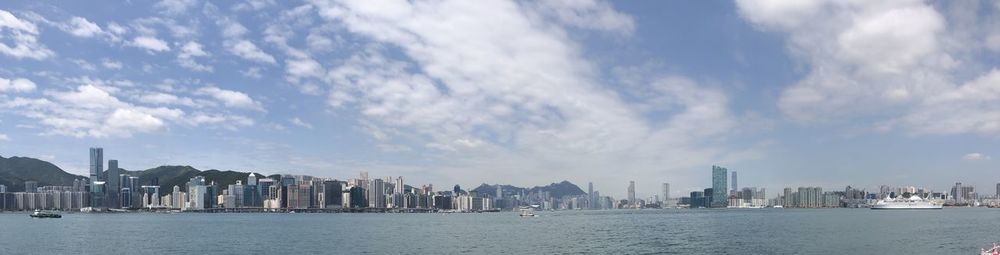 Panoramic view of sea and buildings against sky