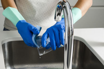 Close-up of hand holding blue water