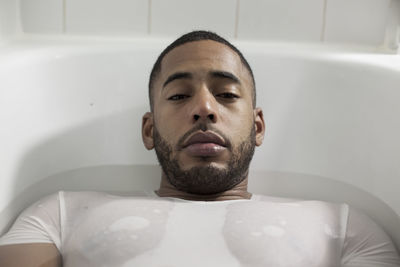 Portrait of young man in bathroom