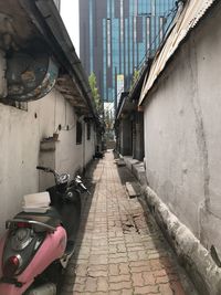 Narrow street amidst buildings in city