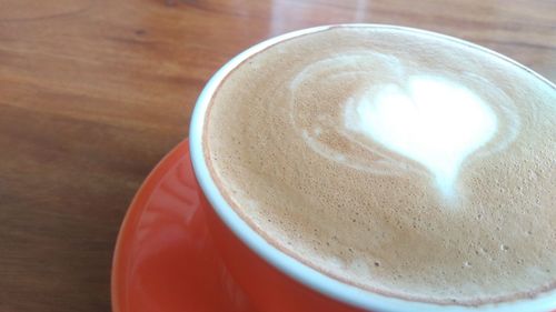 Hot cappuccino on a wooden table 