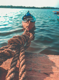 Boat tied with rope on retaining wall