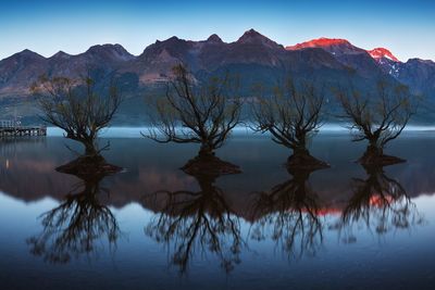 Scenic view of lake and mountains against sky
