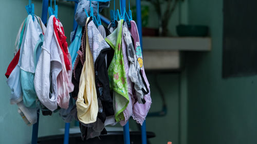 Close-up of clothes drying against wall