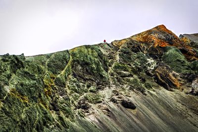 Low angle view of rocks on mountain against sky