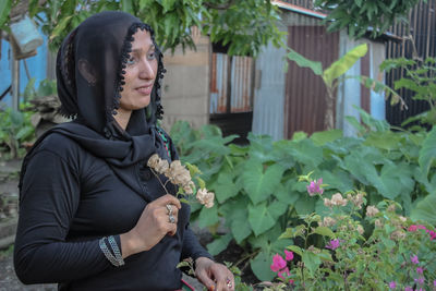 Young woman looking at flowering plants