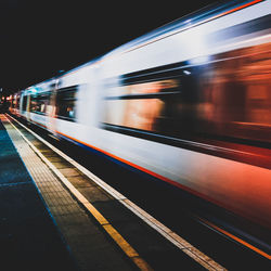 Blurred motion of train at railroad station at night