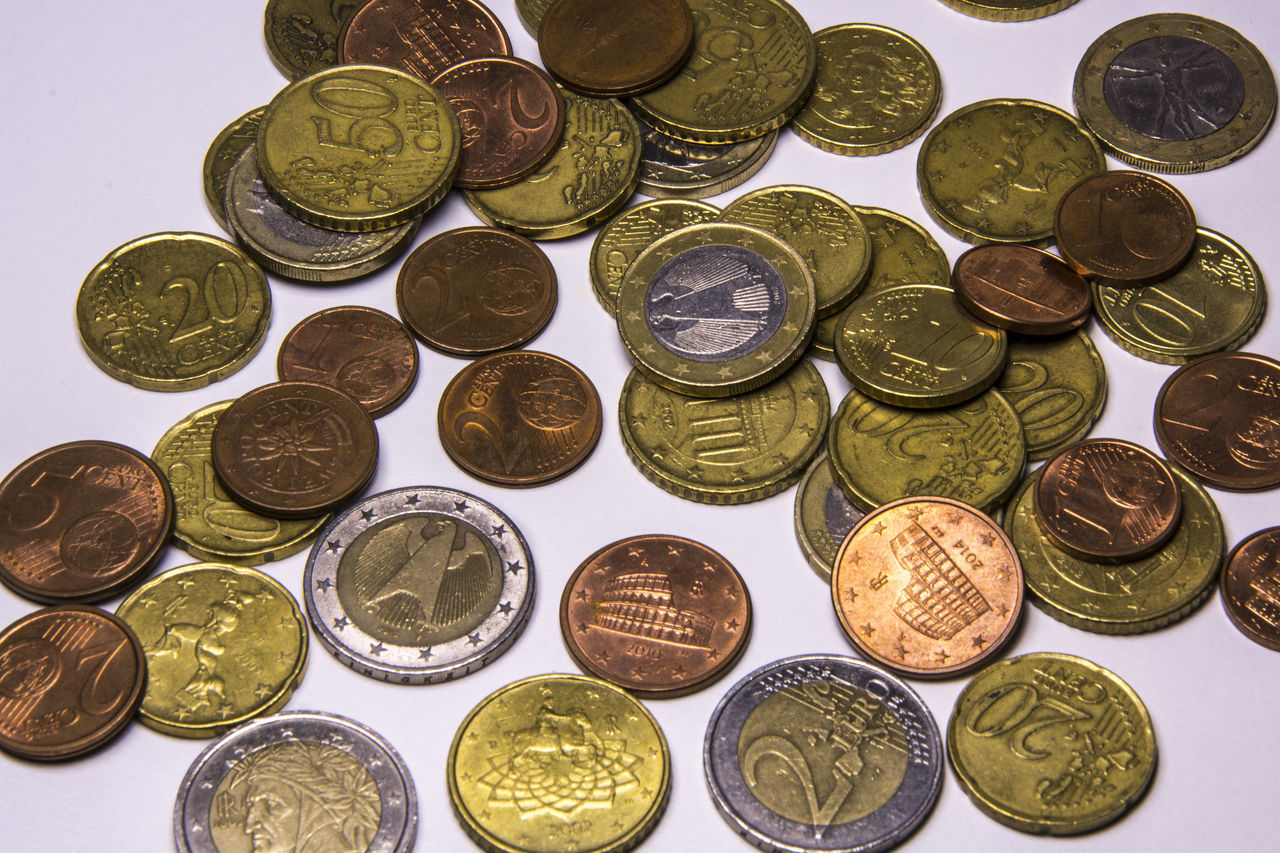 HIGH ANGLE VIEW OF COINS ON METAL