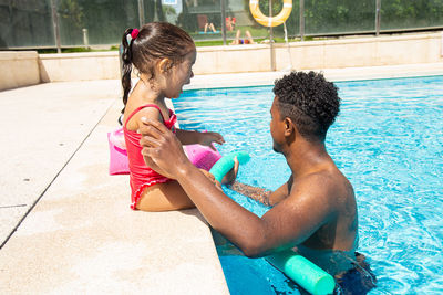 Side view of boy playing in pool