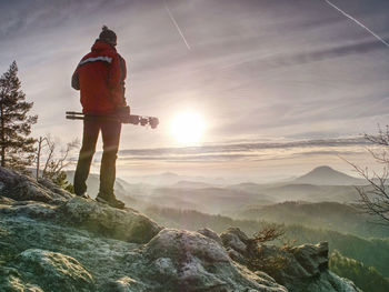 Man photographer taking picture of landscape when sunrise at mountain peak.travel and hobbies